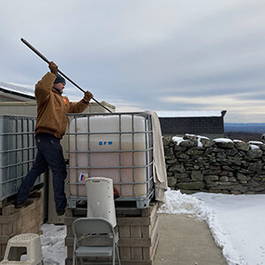 man in winter making ice cider