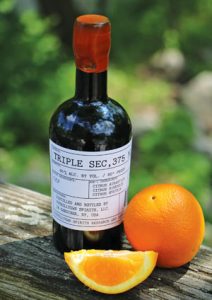 photo of Tuthill Town Distillery bottle of Triple Sec, with an orange and orange slice