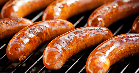 close-up of sausages on grill rack