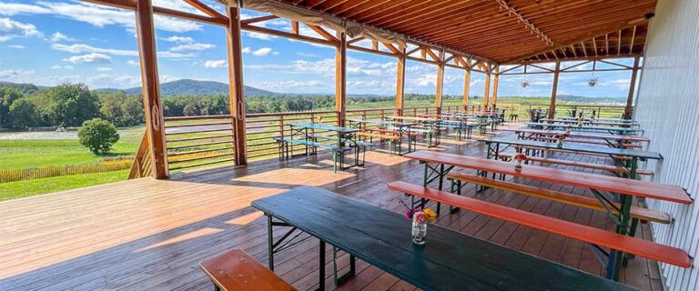 view of covered porch at Treasury Cider with background scenery