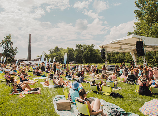 people on lawn enjoying a concert