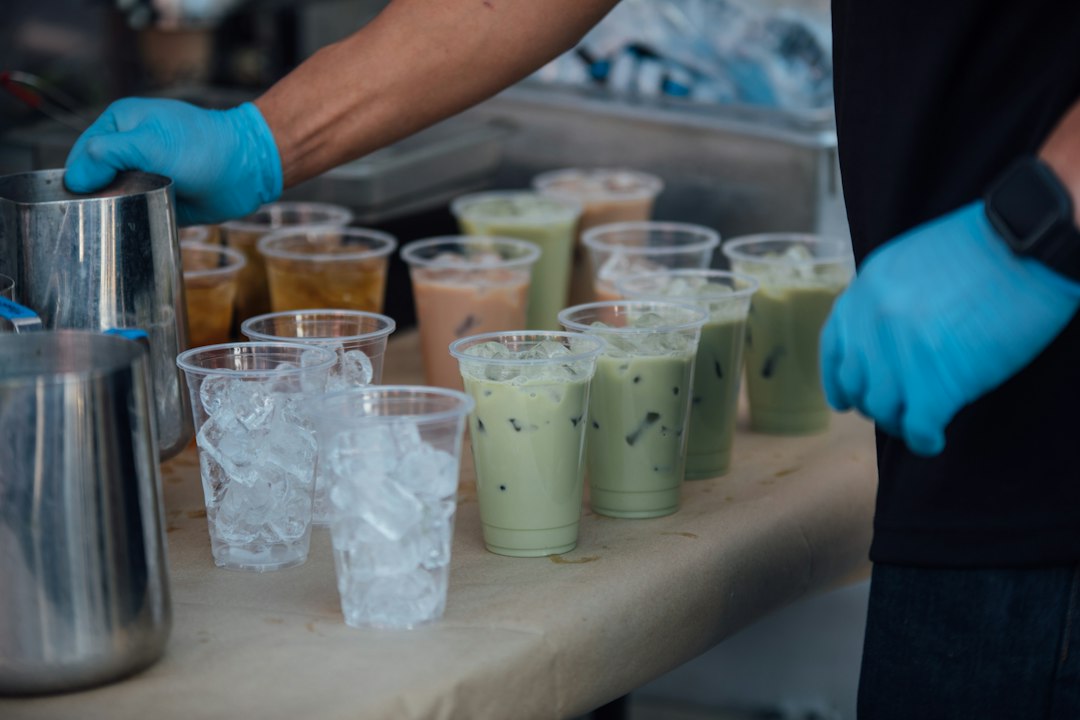 assorted boba tea drinks with colorful toppings and wide straws